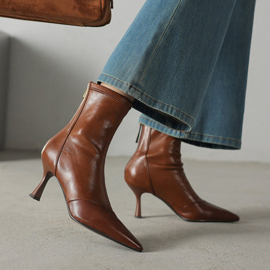 Elegant women's black pointed-toe heeled boots for a confident and sophisticated style statement.