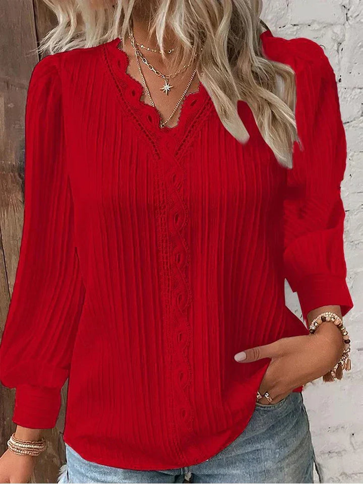 Stylish women's lace blouse with delicate details, a versatile top for elegant womenswear.