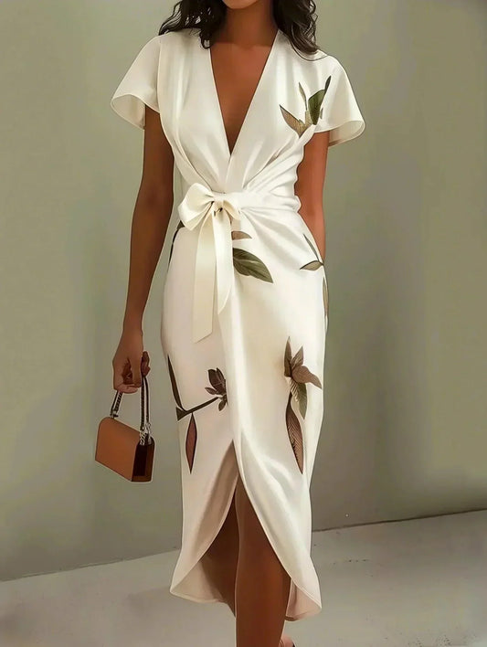 Elegant women's botanical print midi dress with a vibrant floral pattern, V-neck, and chic bow-tie waist.