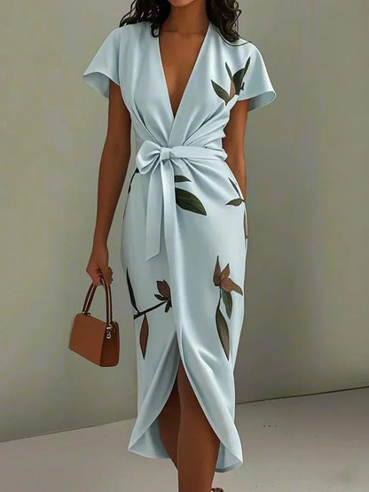 Chic women's floral midi dress, perfect for summer garden parties, featuring flutter sleeves & bow detail.