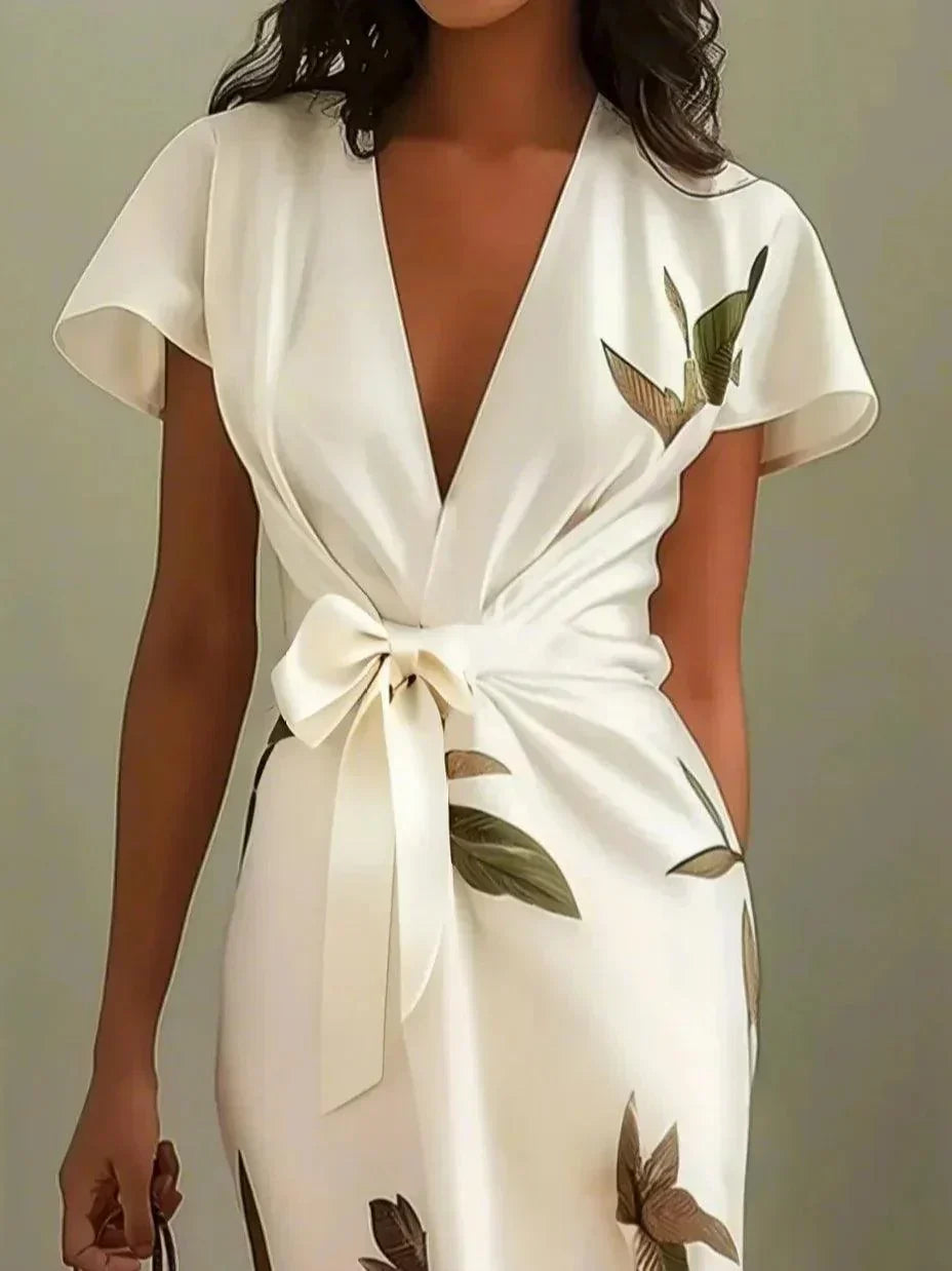 Stylish women's botanical print midi dress with an elegant V-neckline & tie waist for spring fashion.