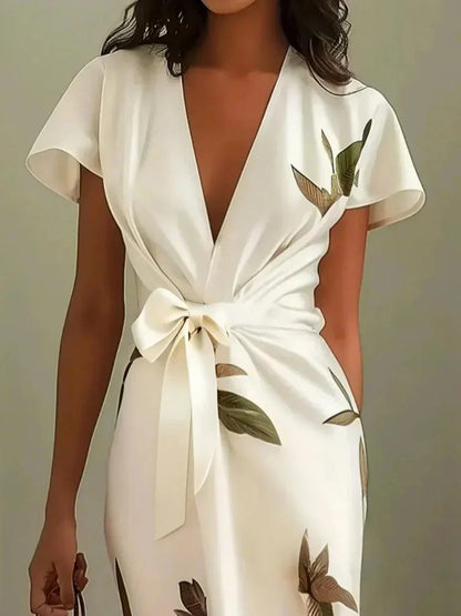 Stylish women's botanical print midi dress with an elegant V-neckline & tie waist for spring fashion.