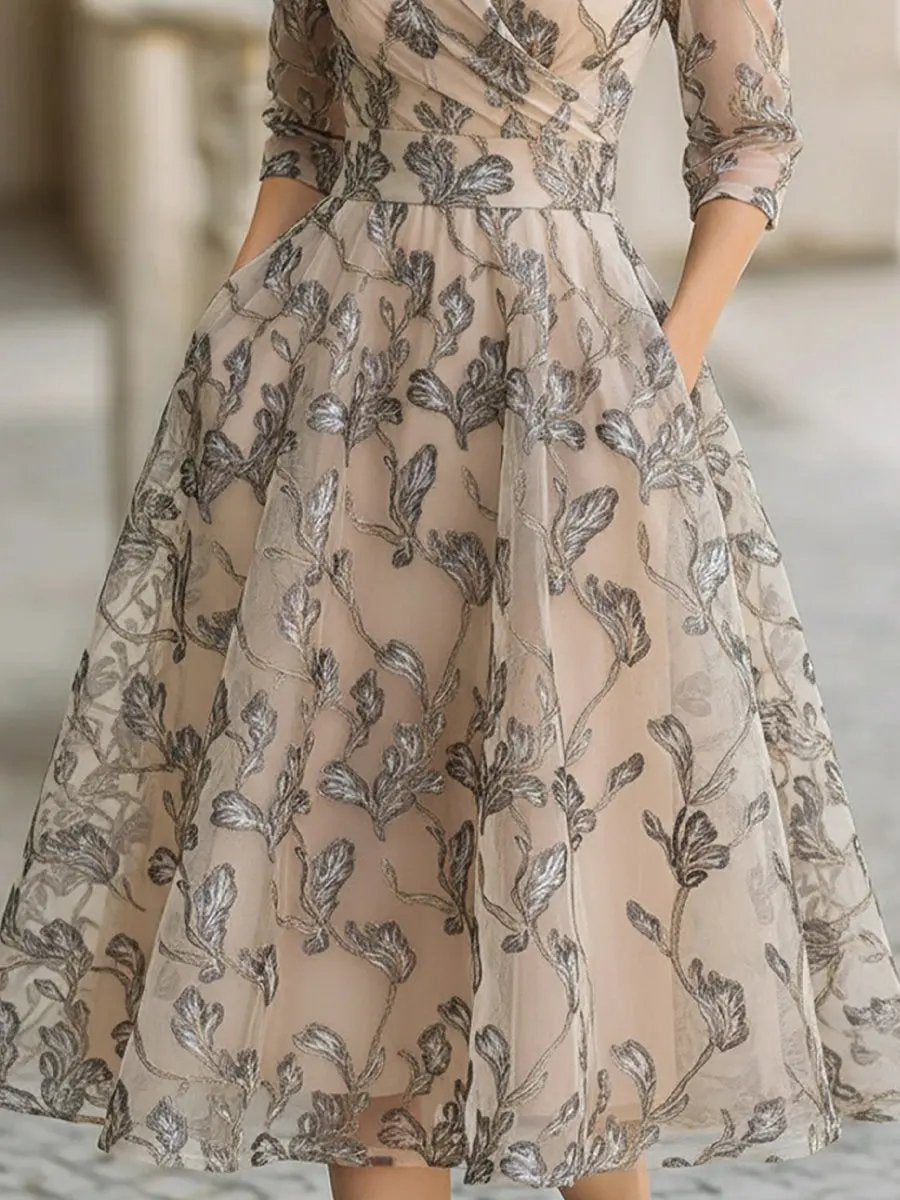 Women's graceful A-line midi dress in champagne, with elegant short sleeves and delicate leaf pattern, perfect for occasions.