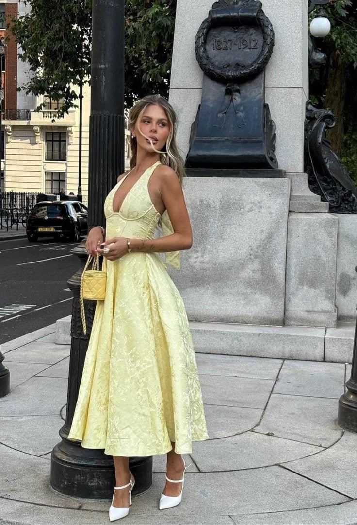 Stylish women's A-line halter midi dress with corset detail, ideal as a party or wedding guest outfit.