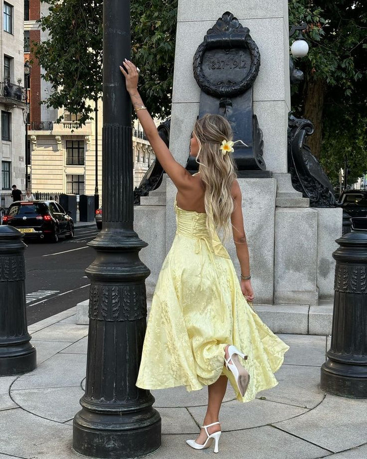 Beautiful A-line halter midi wedding guest dress for women, featuring a flattering corset design.