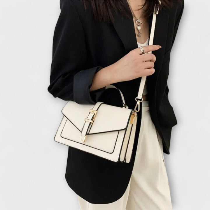 Classic women's shoulder bag with a distinct flap closure, offering timeless elegance for fashion-forward everyday wear.