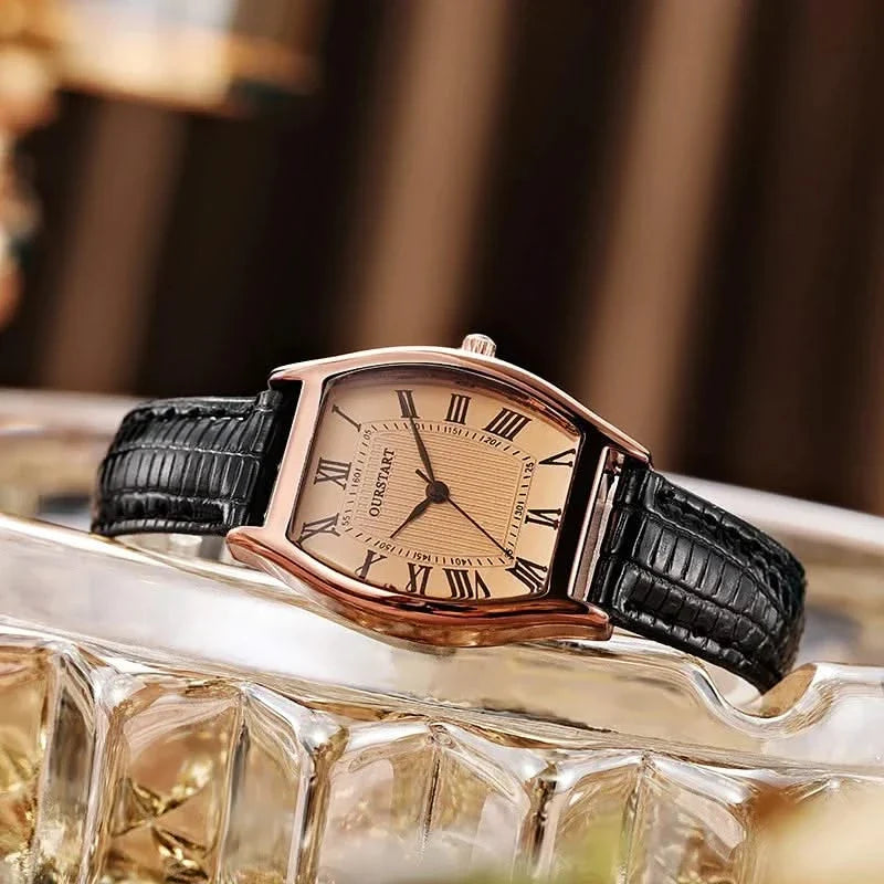 Brown women's classic watch with Roman numerals, polished finish. Versatile for formal or casual chic.