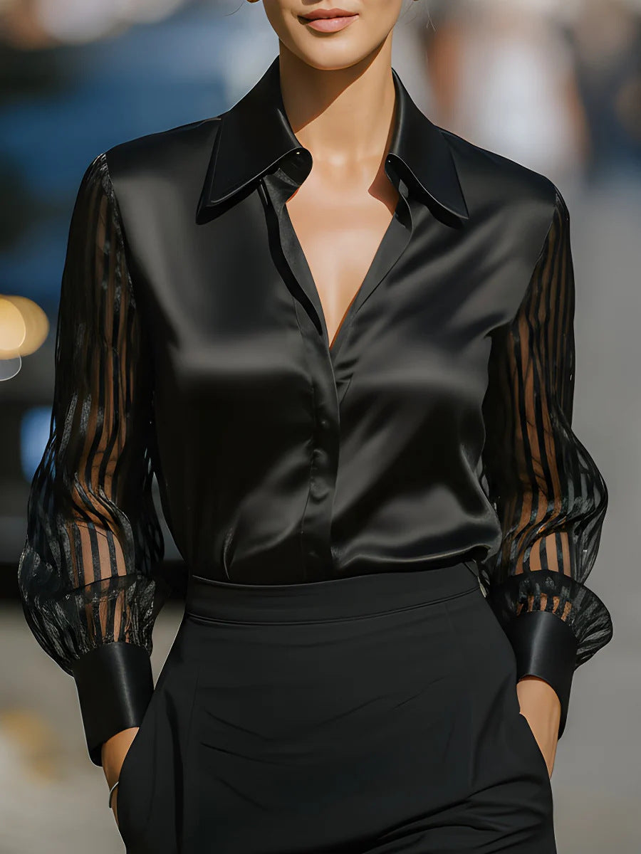 Elegant women's collared button-up top with stylish patterned long sleeves, perfect for business casual.