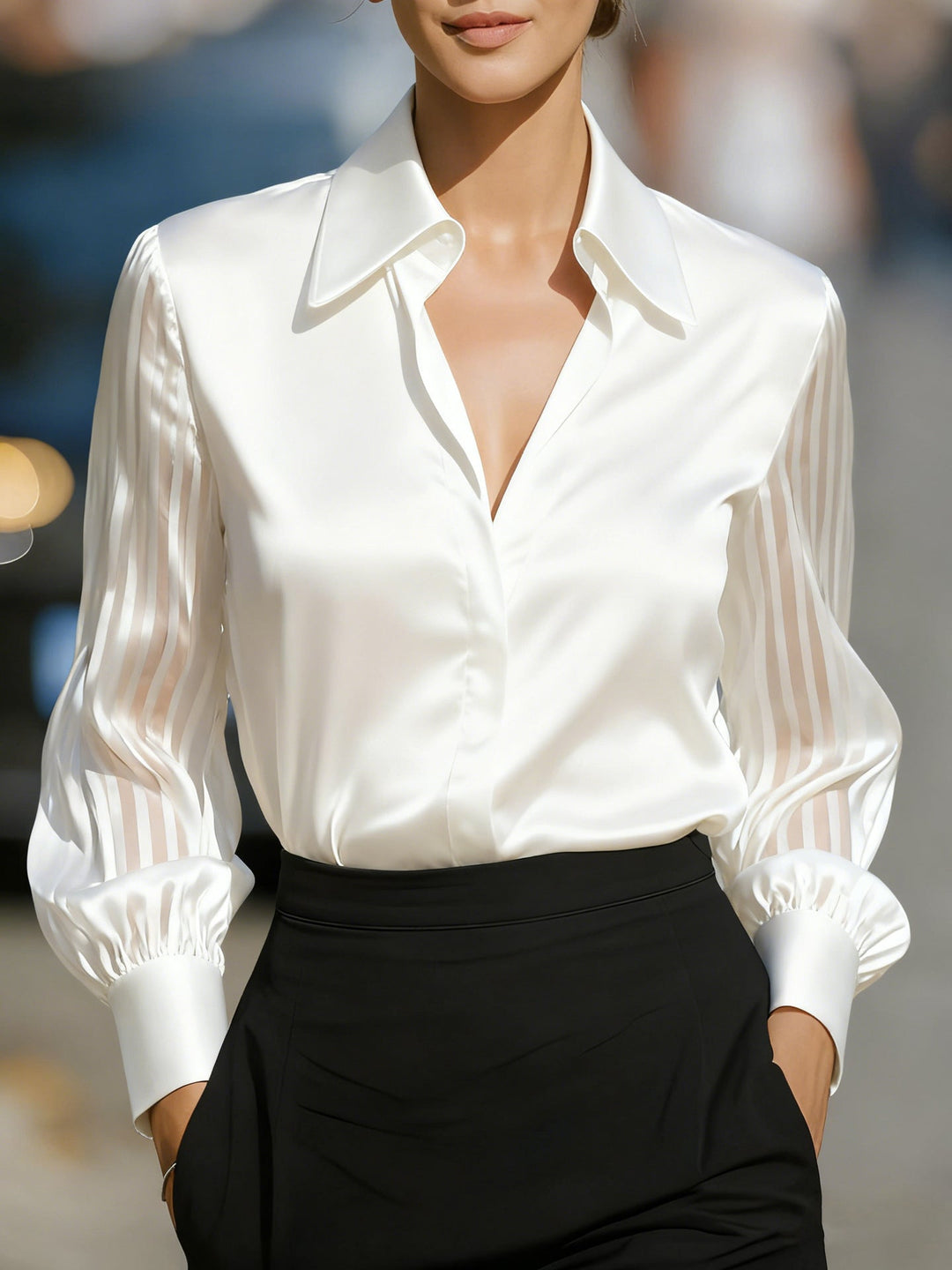 Sophisticated women's button-up blouse featuring an elegant collar and unique patterned sleeves for office wear.