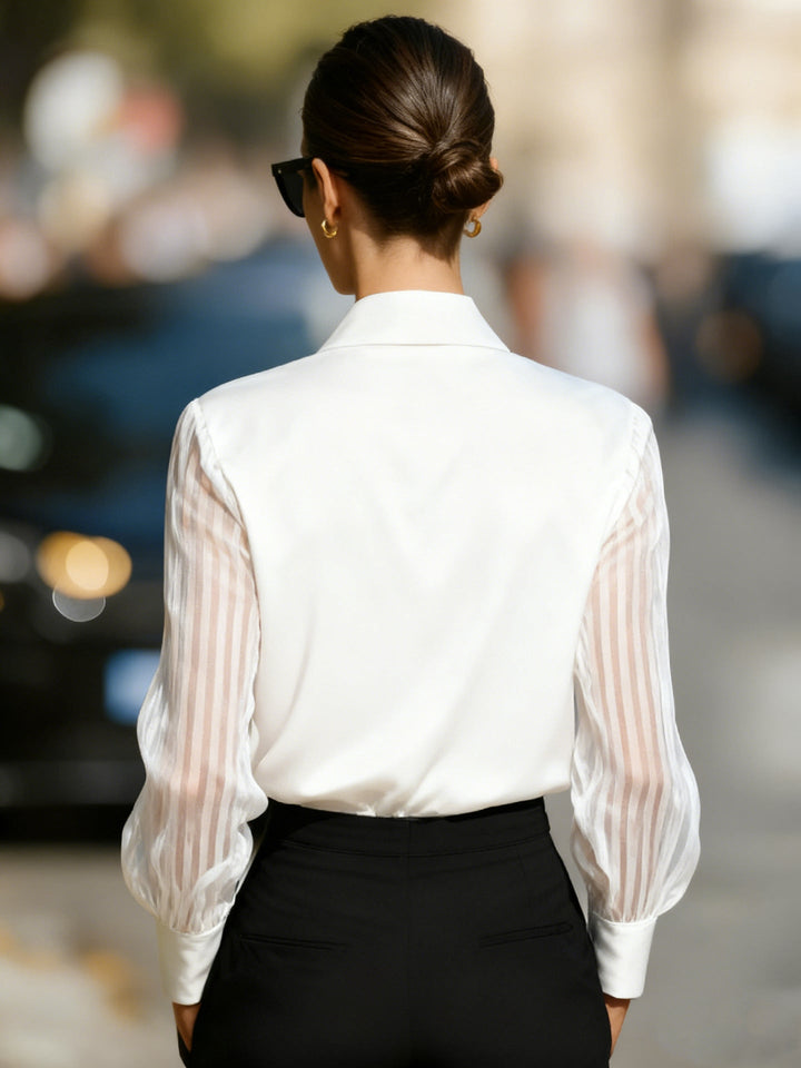 Stylish women's button-up blouse, featuring an elegant collar and eye-catching patterned sleeves for sophisticated fashion.