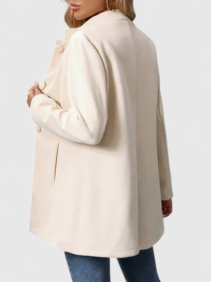 Black elegant collarless jacket for women. Modern style button-front outerwear, perfect for chic workwear.