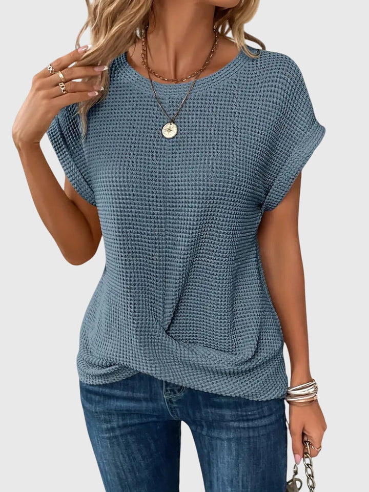 Fashionable women's crew neck blouse. Ideal for elegant workwear, stylish casual looks, and versatile fashion.
