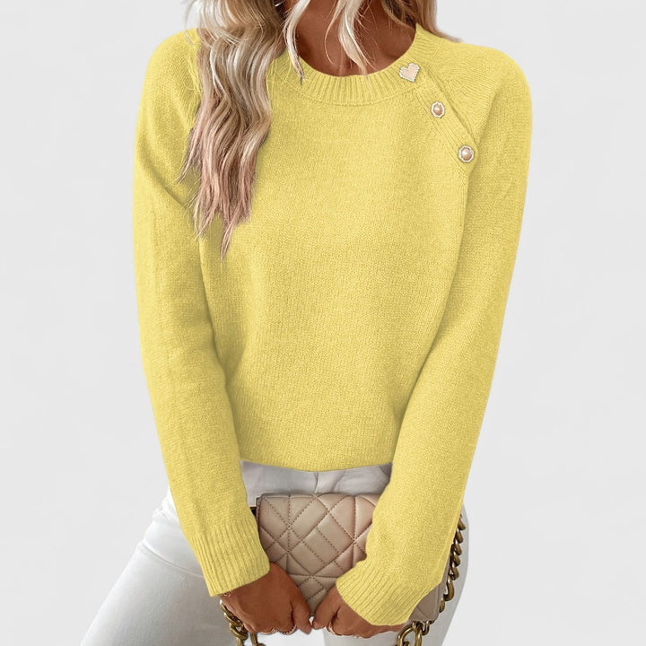 Elegant women's crew neck pullover sweater with subtle pearl button accents. A stylish and versatile long sleeve top.