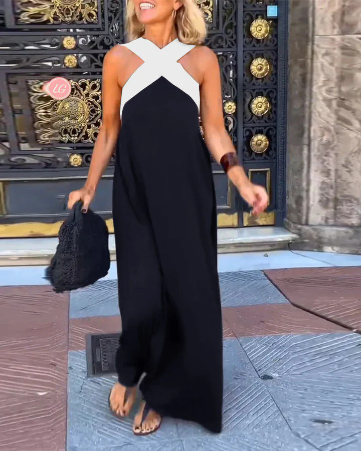 Close-up of the elegant cross neck detail on a women's flowy maxi dress. Sophisticated evening fashion.
