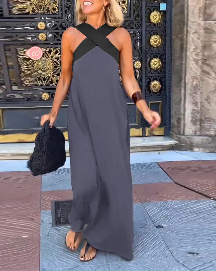 Full shot of an elegant women's cross neck flowy maxi dress. A comfortable and stylish long summer dress.