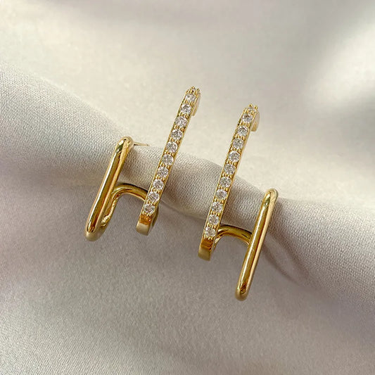 Elegant Women's Crystal Claw Stud Earrings. Sparkly, hypoallergenic gold-plated jewelry for everyday or special occasions.