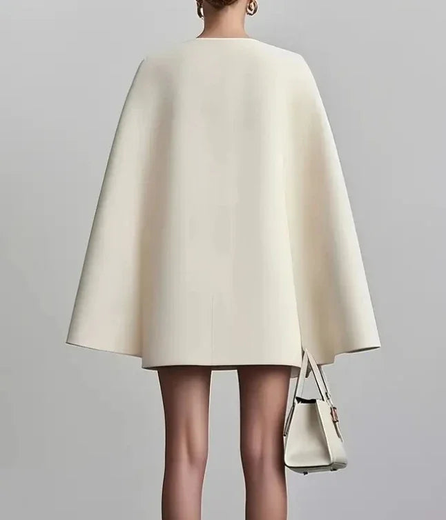 Sophisticated women's tailored mini dress with double-breasted design & cape sleeves, ideal as a power or formal dress.