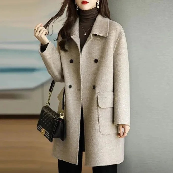 Elegant women's double-breasted structured coat, perfect for a sophisticated winter or autumn tailored look.