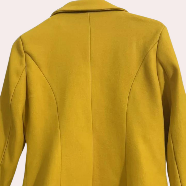 Feminine double-breasted trench coat with a flattering cinched waist, ideal for classic workwear and fall style.