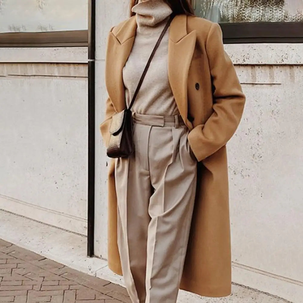 Stylish women's double-breasted trench coat, ideal professional outerwear for spring or fall workwear.