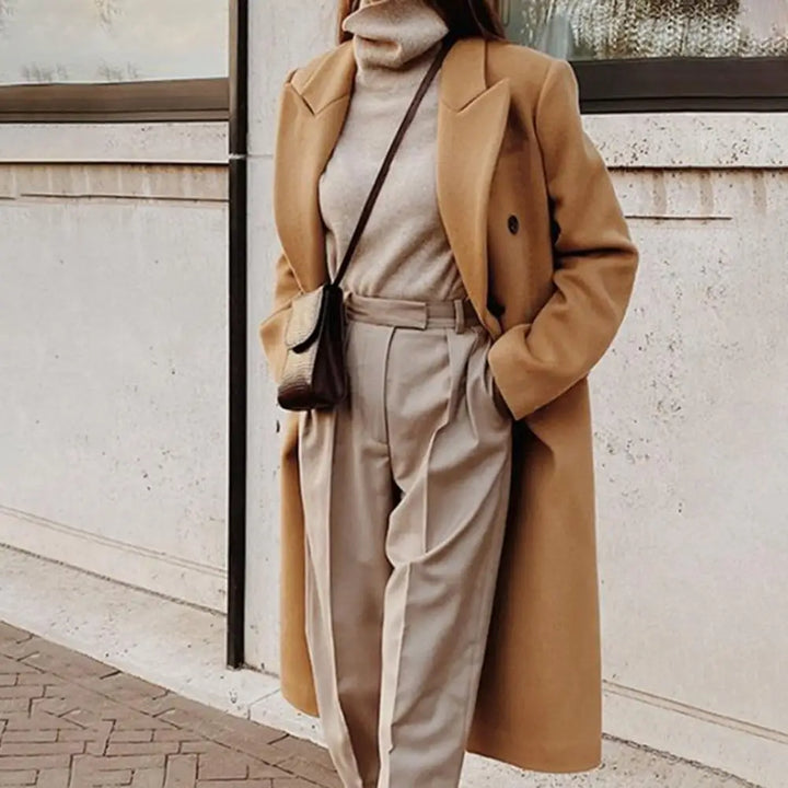Stylish women's double-breasted trench coat, ideal professional outerwear for spring or fall workwear.