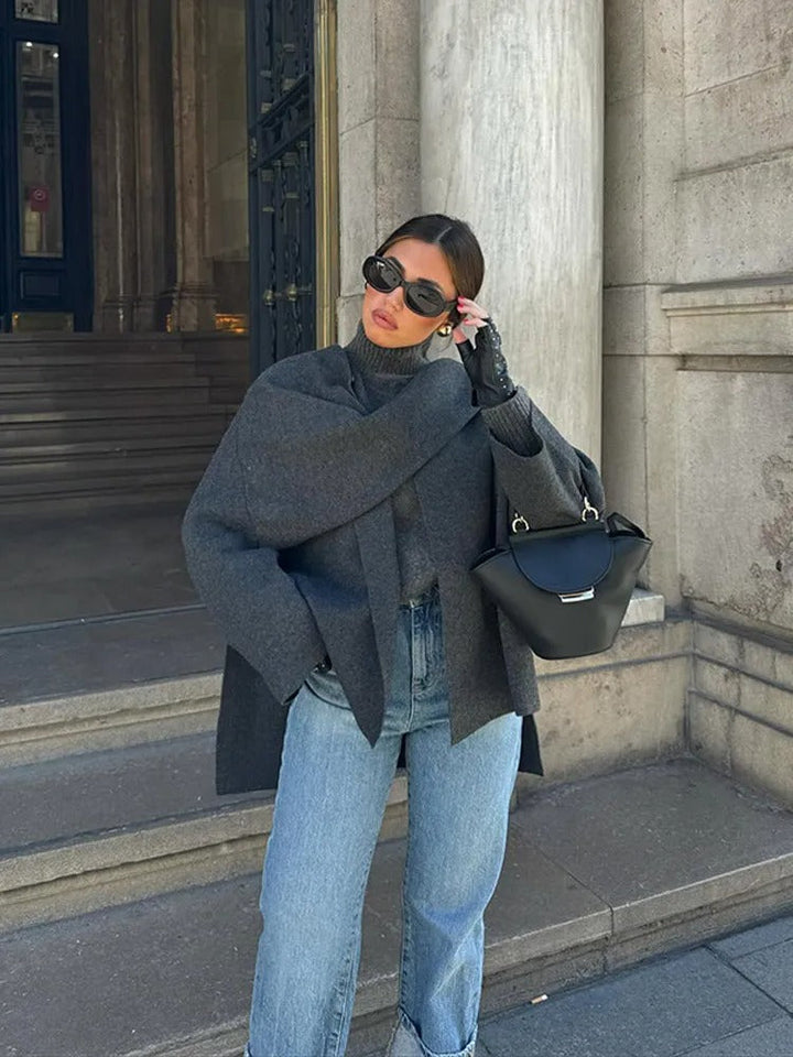 Statement women's cape coat with an effortless drape. Asymmetrical design, chic outerwear for transitional fall and winter fashion.