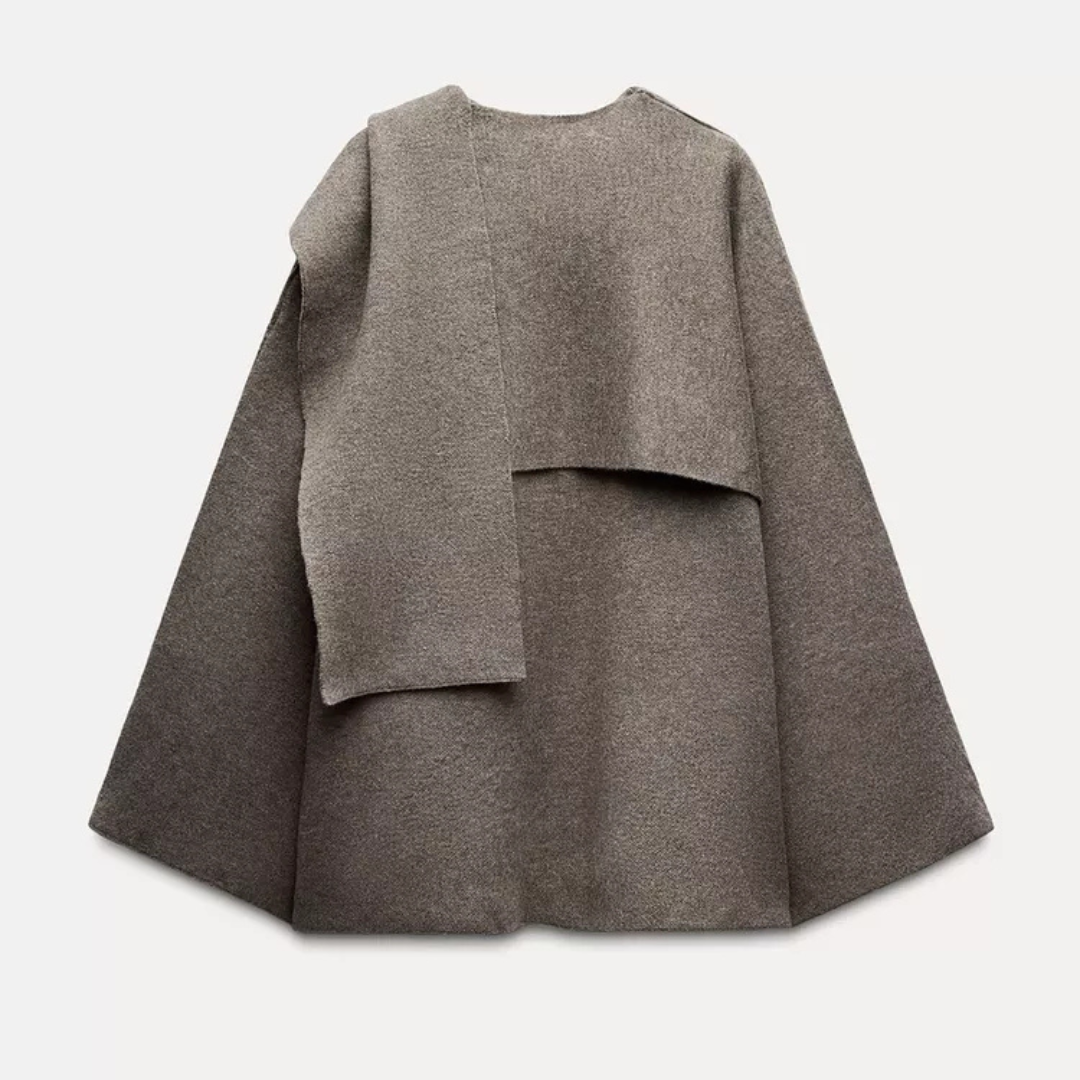 Comfortable women's flowing drape cape coat. Versatile layering piece for fall & winter, offering elegant, chic outerwear style.