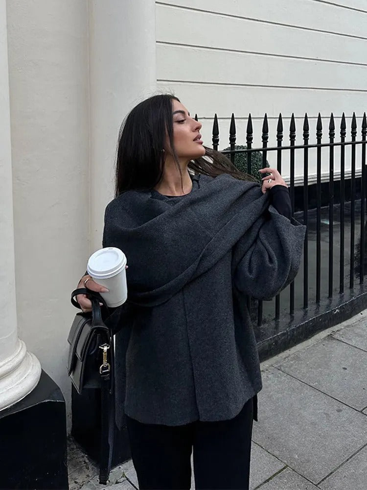 Modern women's asymmetrical drape cape coat. Chic, flowing outerwear for all seasons, perfect for an elegant fashion statement.