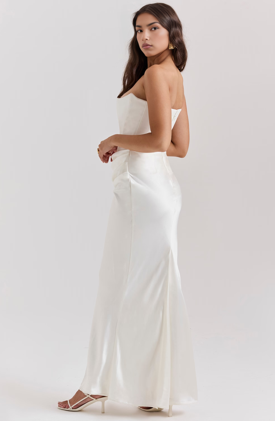 Formal women's strapless wedding guest dress, with elegant draping.