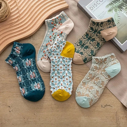 Delicate vintage lace socks for women, featuring elegant embroidery. Stylish mid-calf/ankle fashion accessory.