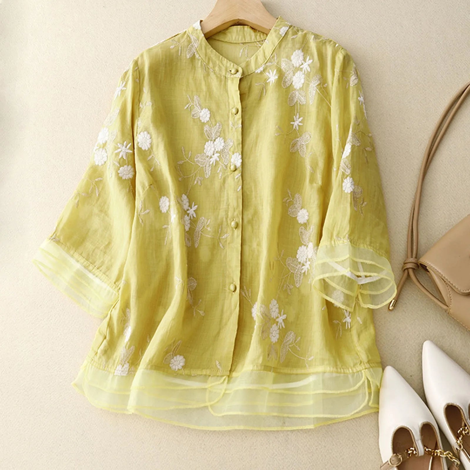 Chic women's floral blouse, a romantic sheer top for elegant daytime wear.