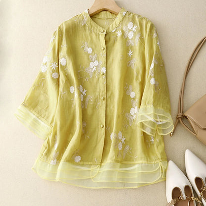 Chic women's floral blouse, a romantic sheer top for elegant daytime wear.