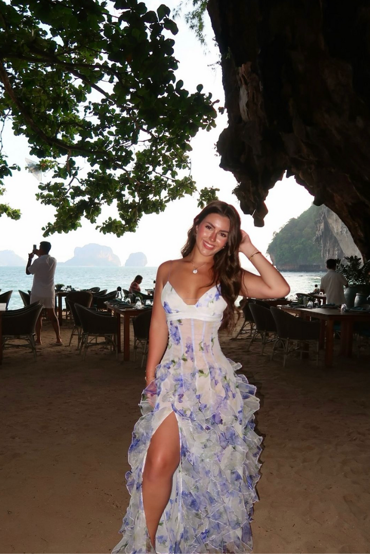 Flowing floral ruffle maxi dress for women, featuring a structured corset top. Perfect blue formal guest dress.