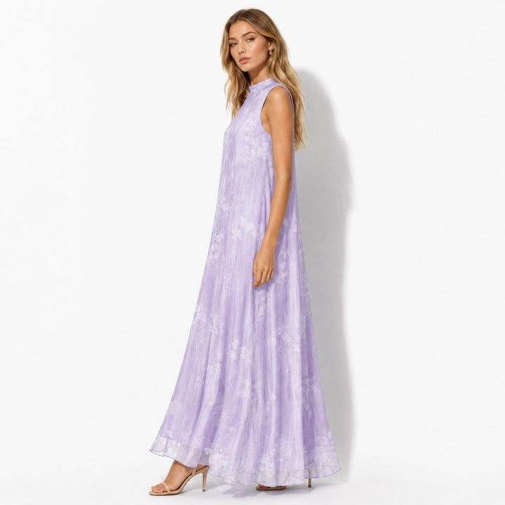 Close-up of women's floral maxi dress: high neck, elegant print, ideal formal gown for wedding guests.