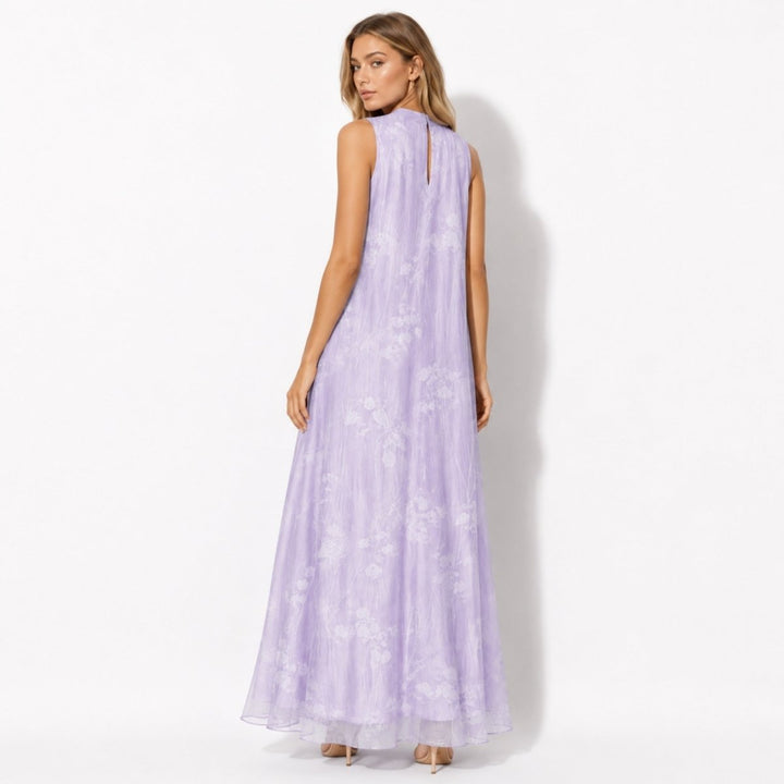 Model wearing a flowing women's floral high neck maxi dress, suitable long formal gown for wedding guests.