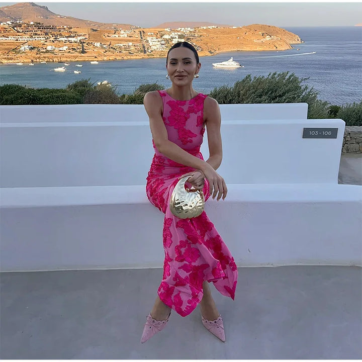 Women's sleeveless high-neck floral maxi dress, perfect pink wedding guest attire. Elegant column style gown.