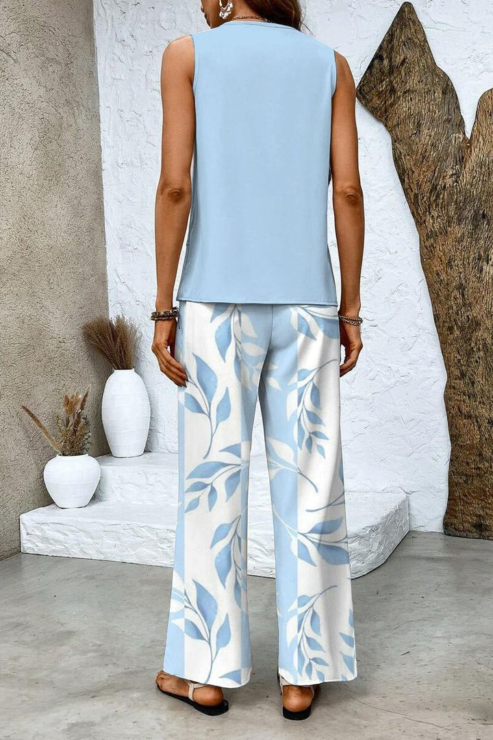 Chic women's floral two-piece set featuring a stylish top and comfortable trousers. Effortless spring outfit.