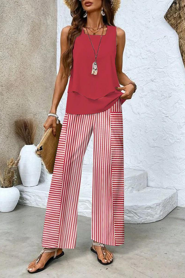 Matching women's floral top and trouser set. Perfect elegant two-piece outfit for summer and spring comfort.
