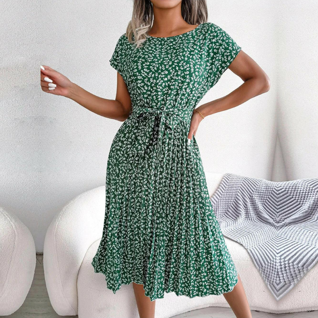 Flowy women's midi dress with a vibrant floral print and elegant pleated skirt. Comfortable fashion.