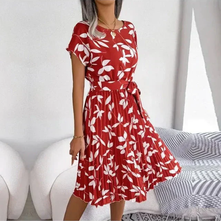 Beautiful women's pleated midi dress featuring an eye-catching floral print. Perfect for warm weather.