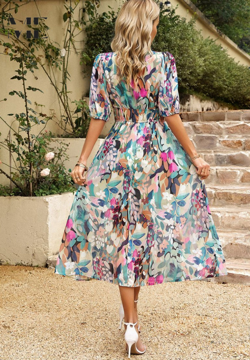 Close-up of vibrant floral print on elegant women's midi dress, featuring soft fabric and intricate pattern.