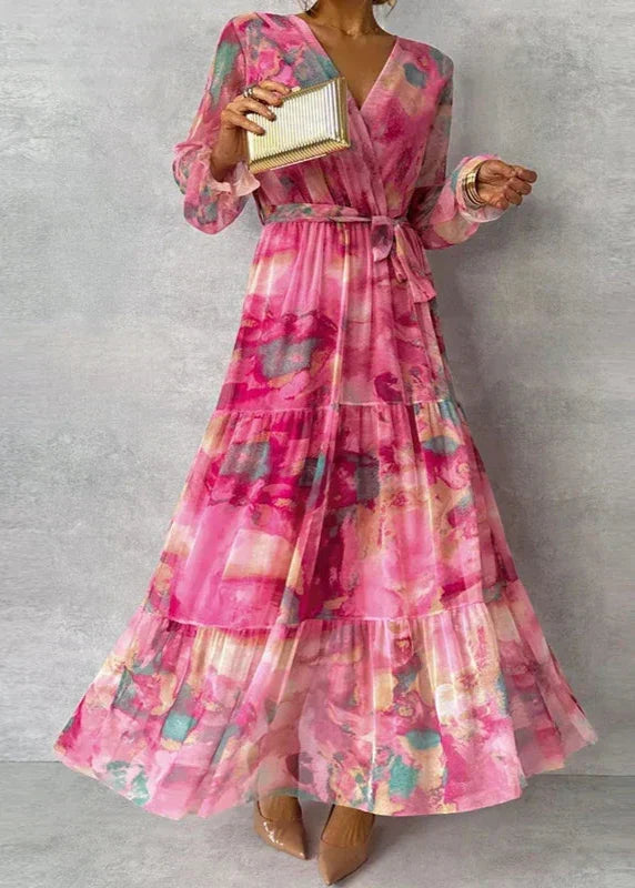 Romantic women's floral wrap maxi dress with V-neck, billowing sleeves, and tiered skirt. Ideal for a summer wedding.