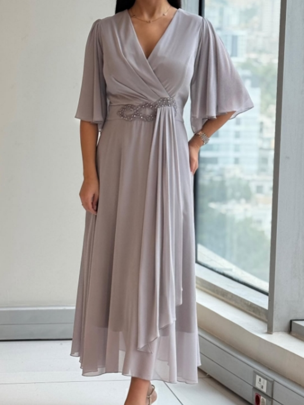 Elegant women's flowing V-neck maxi dress with adjustable straps, perfect for evening or casual wear.