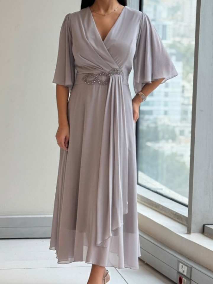 Elegant women's flowing V-neck maxi dress with adjustable straps, perfect for evening or casual wear.