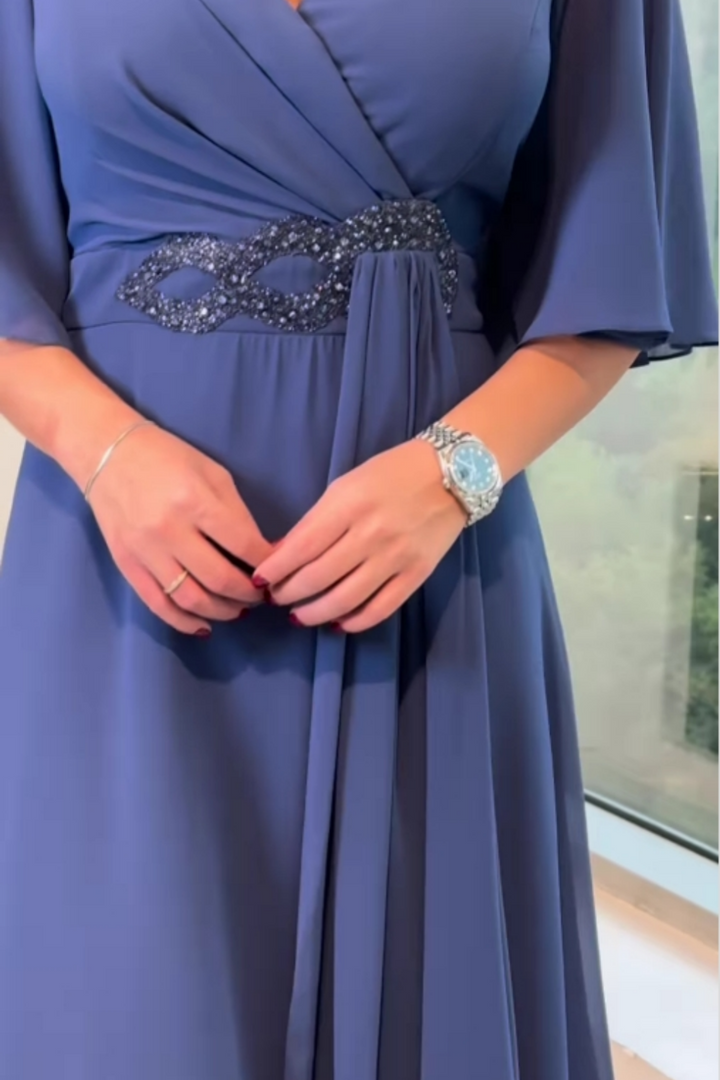 Stylish women's flowing V-neck maxi dress with adjustable straps, offering comfort and elegance.