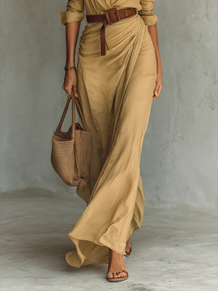 Women's elegant V-neck flowy long dress with a flattering belted waist for spring fashion.