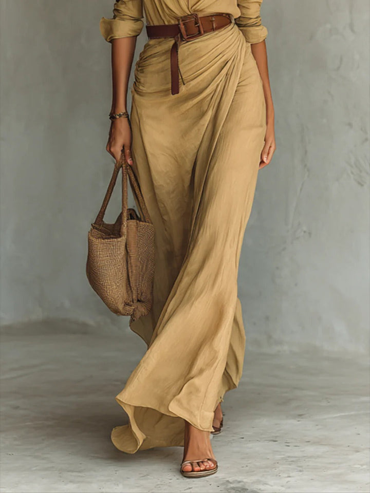 Women's elegant V-neck flowy long dress with a flattering belted waist for spring fashion.