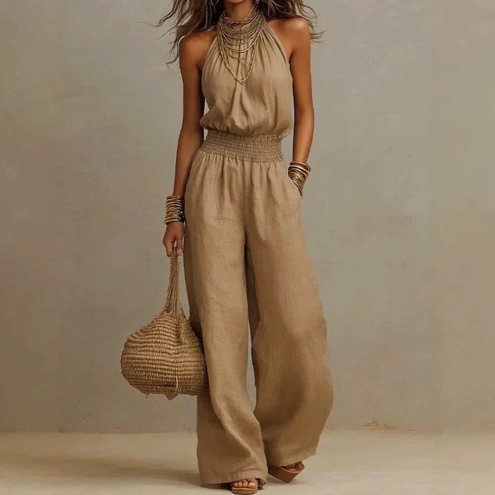 Elegant women's flowy wide leg halter neck jumpsuit for comfortable summer casual and resort fashion.