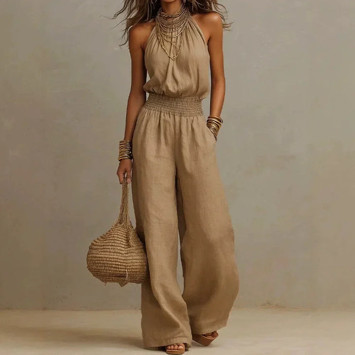 Elegant women's flowy wide leg halter neck jumpsuit for comfortable summer casual and resort fashion.