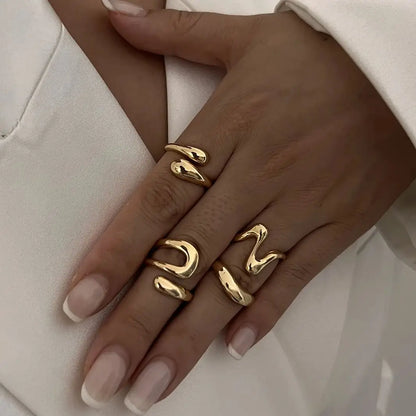 Elegant women's fluid sculptural ring set in gold, a modern fashion accessory.